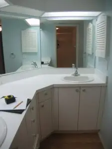 Before photo of the outdated Perico Island condo master bathroom with an 80s-style