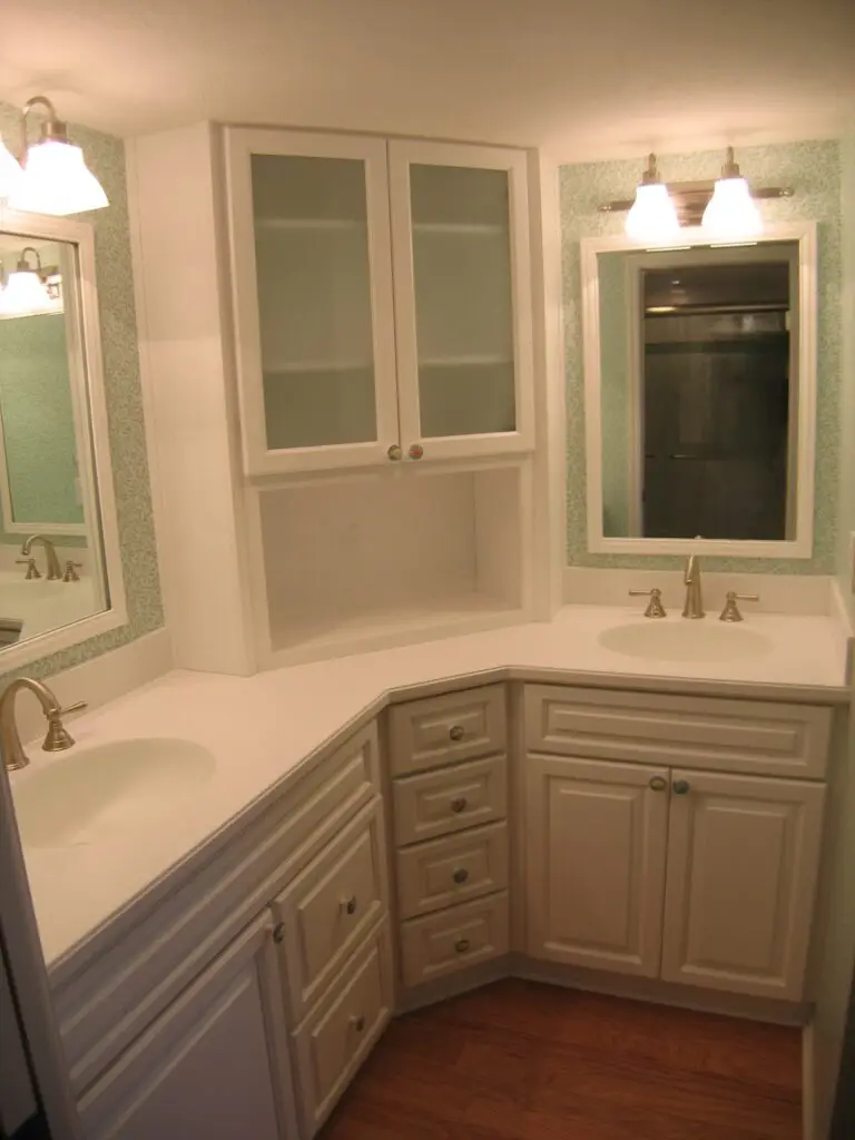 Finished Perico Island master bathroom with white Stressless Cabinetry, oak floors, and solid surface countertops.