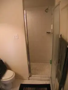 His claustrophobic shower stall before the renovation