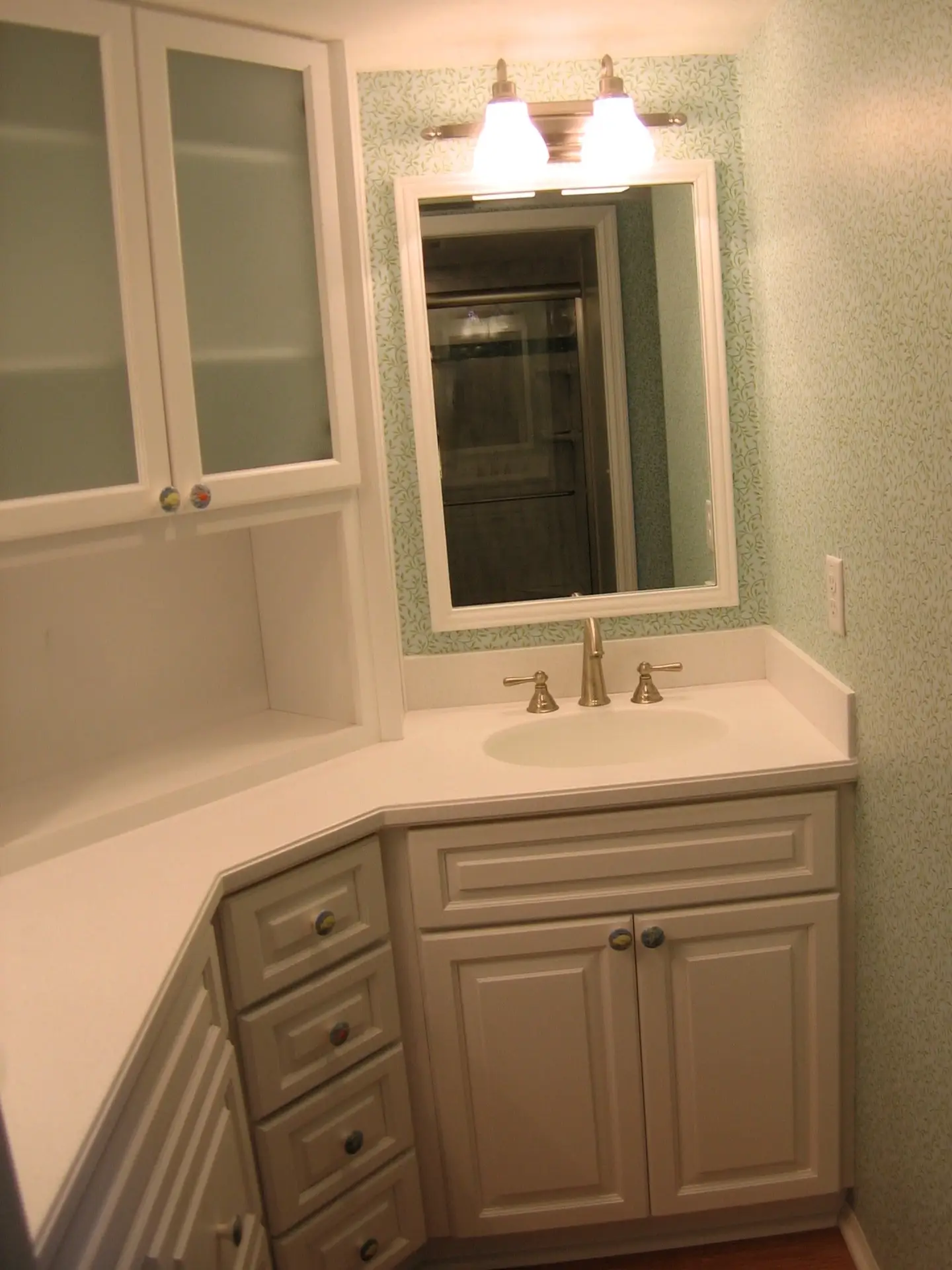 Stressless Cabinetry with white Sanctuary doorstyle, frosted glass inserts, and white countertops