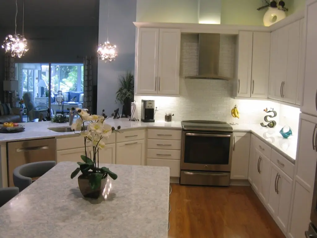 A stunning, modern kitchen with white cabinets and a large island, showcasing professional remodeling results