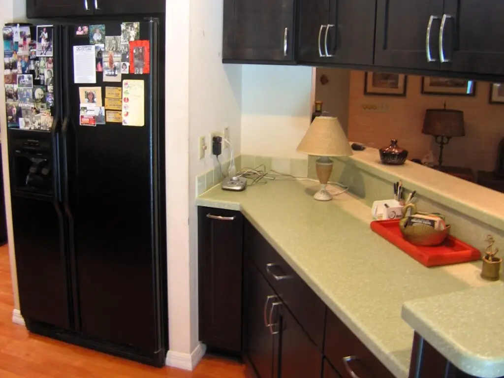 A view of a seafoam green solid surface countertop, highlighting the seamless join with the backsplash