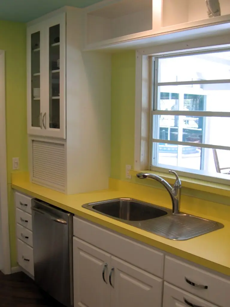 Close-up of bold yellow laminate countertops that are the focal point of the kitchen renovation