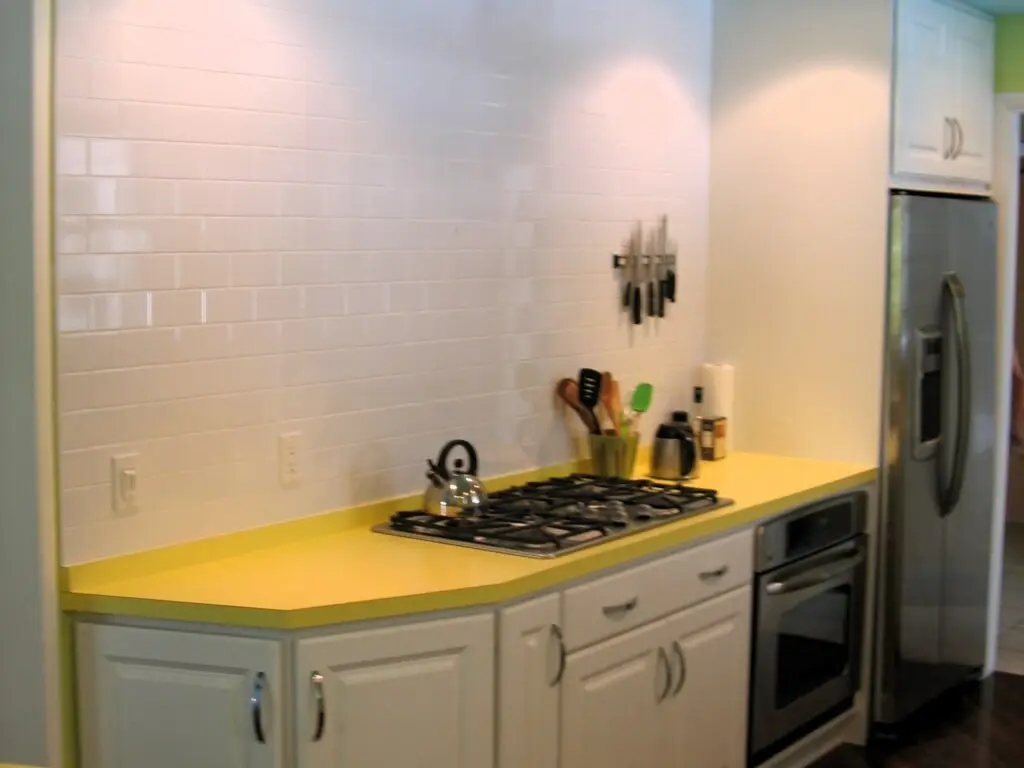 Close up of built in appliances and white subway wall tile