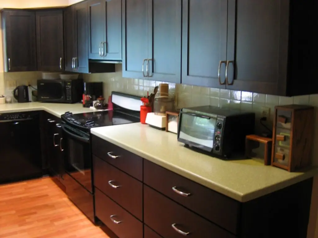 a modern kitchen with Stressless maple cabinets and seafoam green solid surface countertops