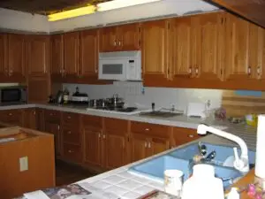 Before photo of tile countertops and oak cabinets in a Palmetto kitchen