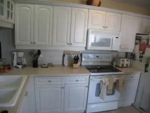 Before photo of white cabinets and white appliances without adequate storage
