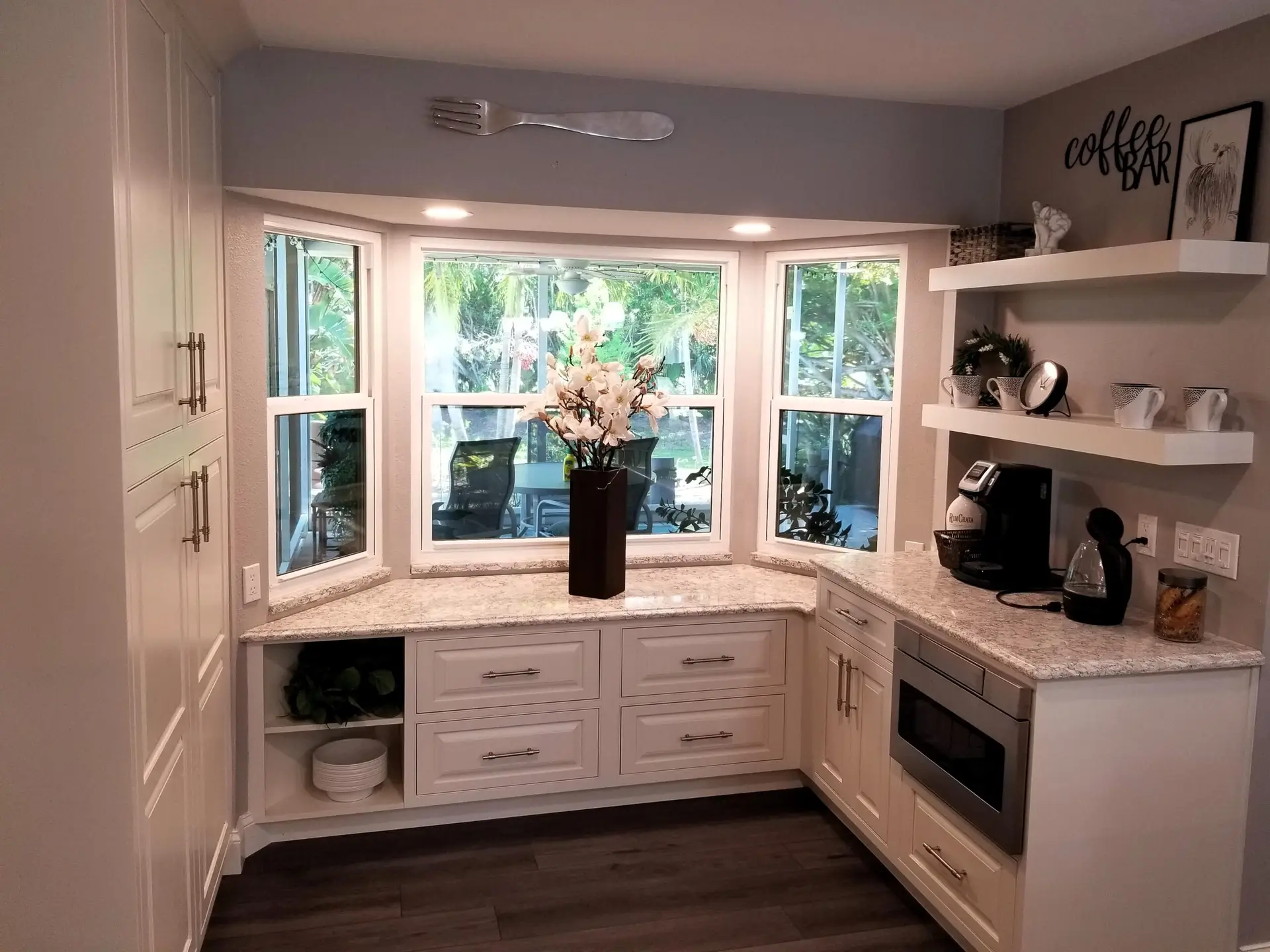 Plenty of custom cabinet storage in an unused breakfast nook and bay window