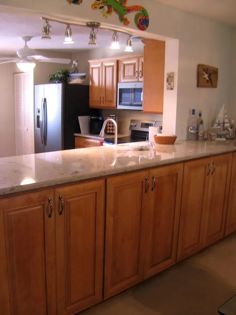 Unused bar stool area bcomes much needed storage space with the addition of custom cabinets and countertops