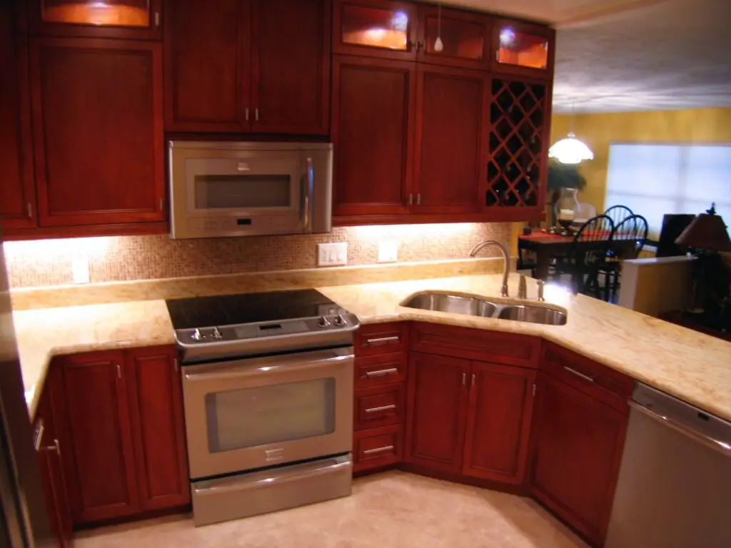 Cherry shaker style cabinets with Kashmir Gold granite countertops and wine rack