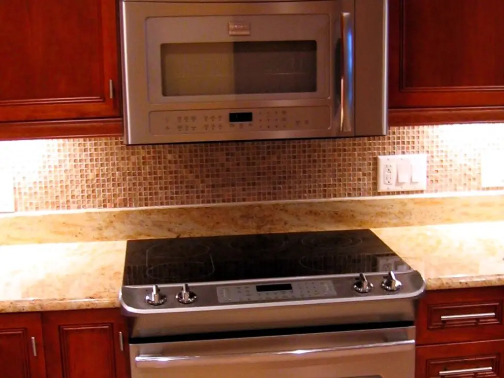 Close-up of mosaic glass and stone backsplash tile in a kitchen remodel
