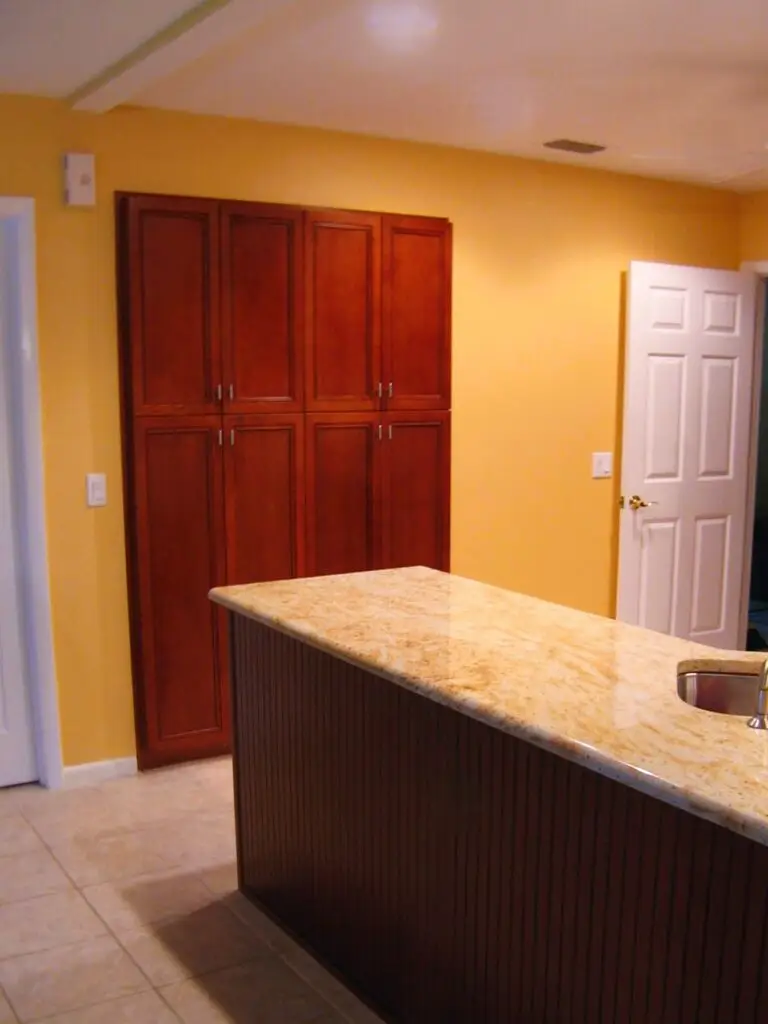 Custom kitchen pantry with roll out trays and interior cabinet accessories