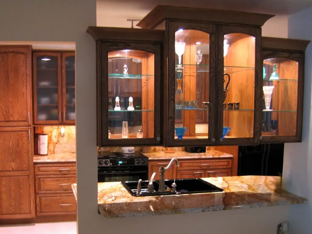 Granite countertop pass thru display cabinetry clear glass StarMark oak