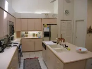 Mauve cabinets and almond appliances are waiting for an update in this before photo