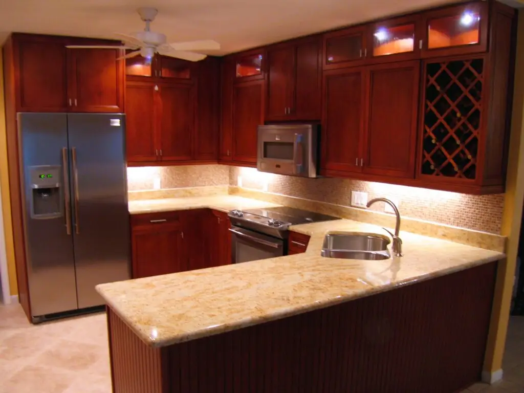 Warm and traditional Holmes Beach kitchen remodel with dark cherry cabinets
