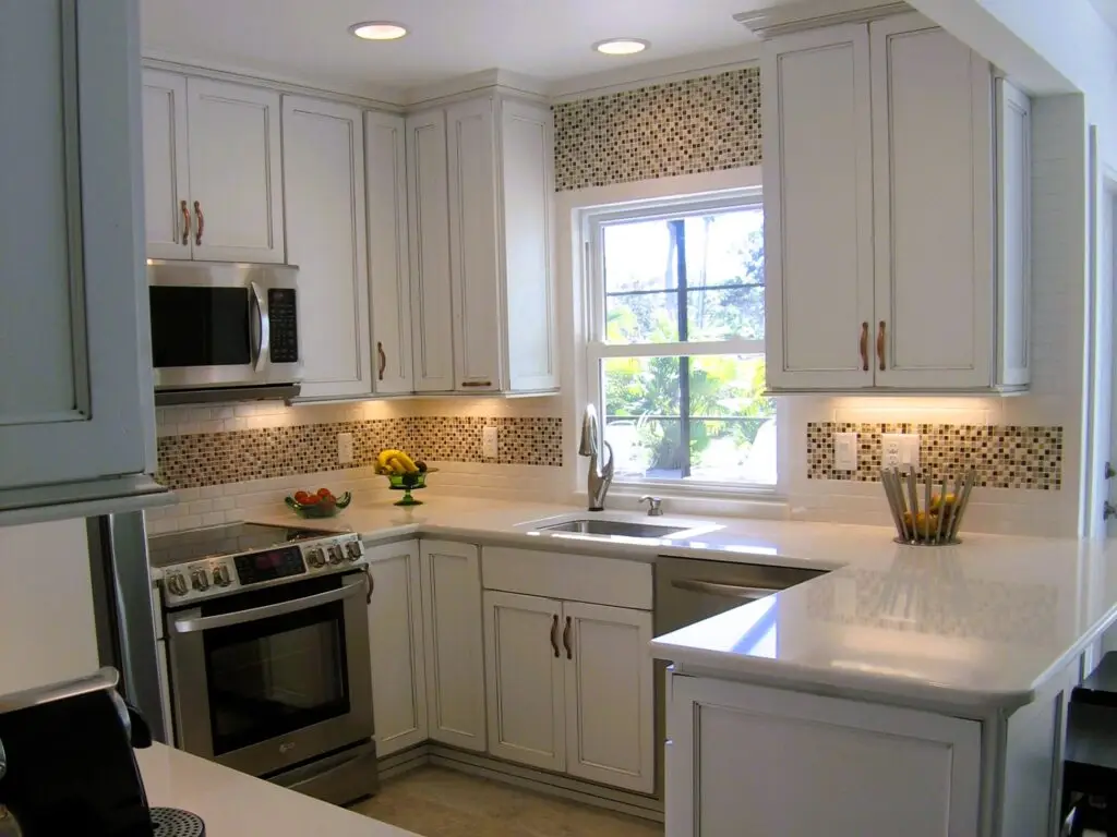 White StarMark cabinetry with Cottage finish, Cambria Dovedale countertops, and mosaic tile backsplash detail