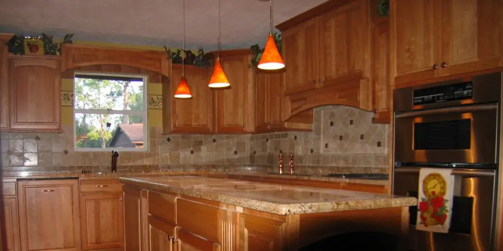 Wide view of a finished Custom Cherry Kitchen Remodel in Lakewood Ranch with a granite island and wood floors