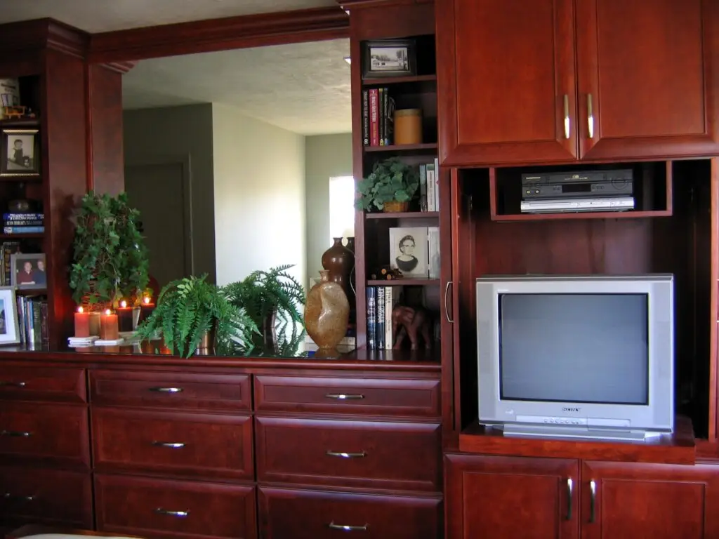 Built-in entertainment center with pocket doors open to reveal a hidden TV.