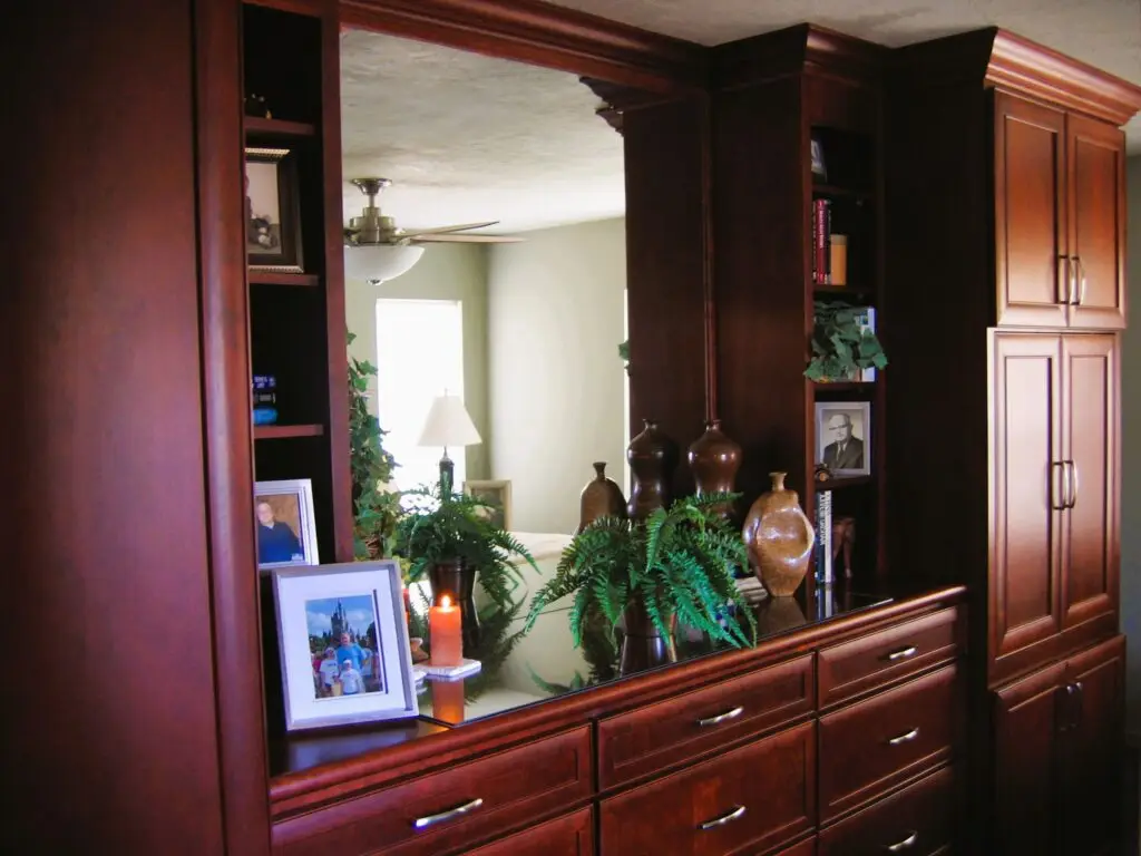 Custom bedroom built-in with bookcases, mirror, and dresser for elegant storage