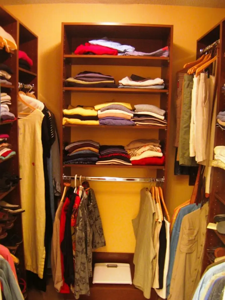 Wide shelving tower in a custom closet with warm cherry finish