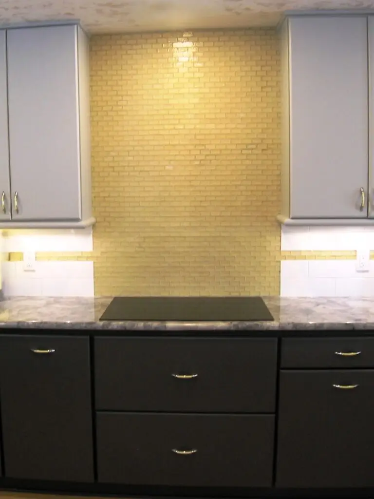 A large block of yellow accent tile to replace upper cabinetry on a long wall