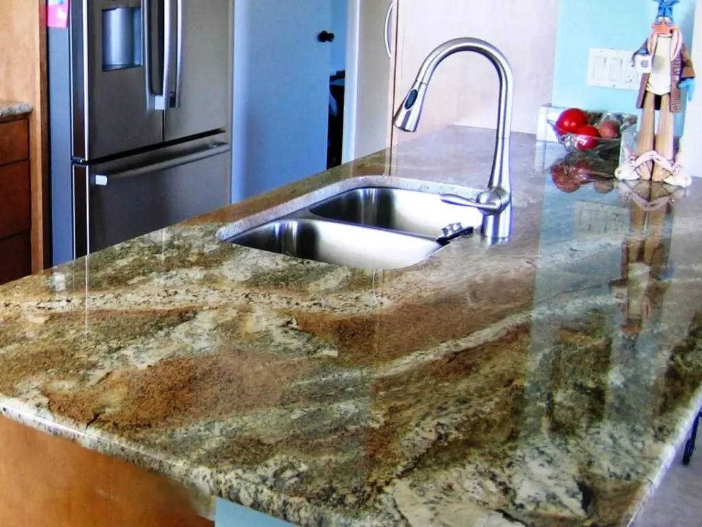 The bold movement of Neptune Bordeax granite on display in this kitchen countertop