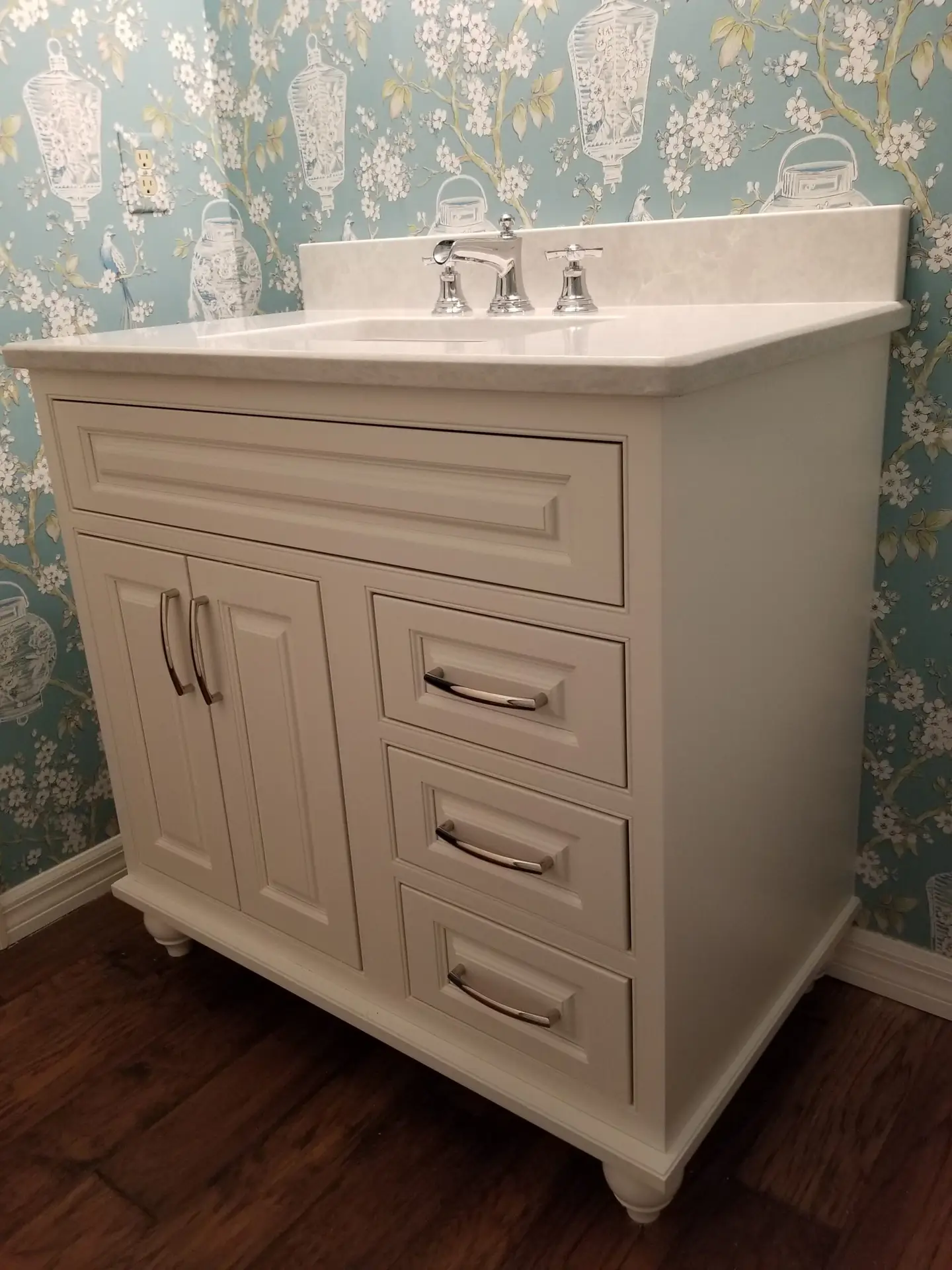 furniture vanity with feet and bold wallpaper in a small modern bathroom
