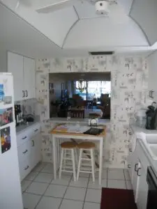 Before, a small dining table ate up too much space under a dated, domed ceiling