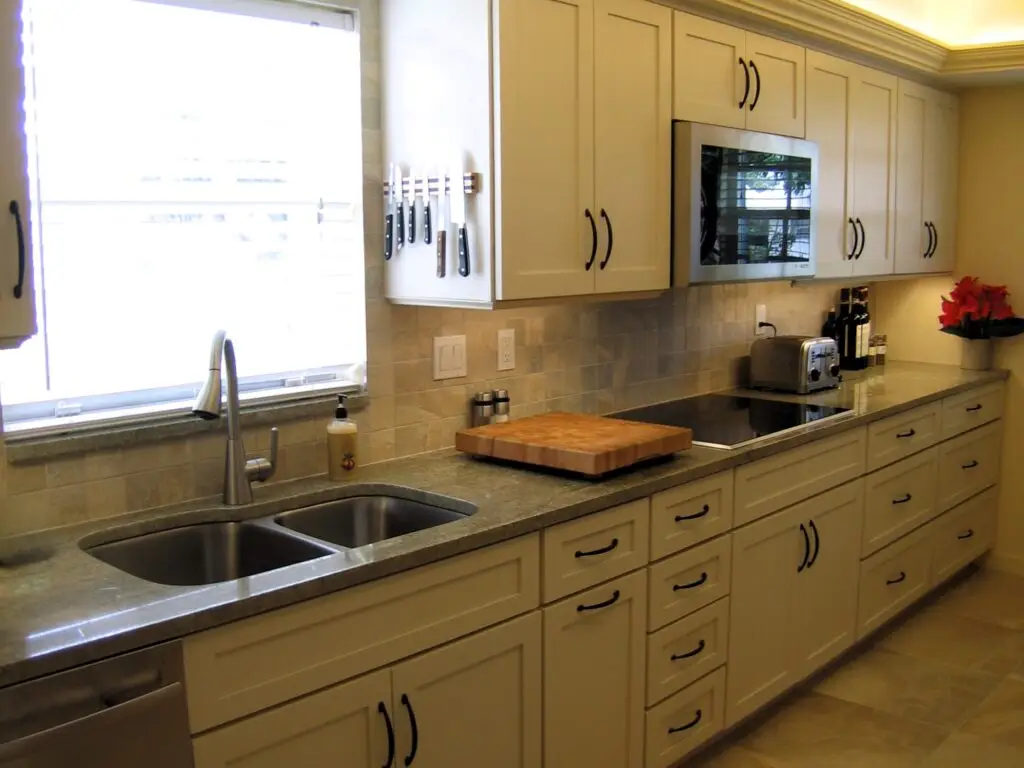 Warm almond painted cabinetry and Green River granite in a recent Mt Vernon kitchen remodel fit for a serious cook