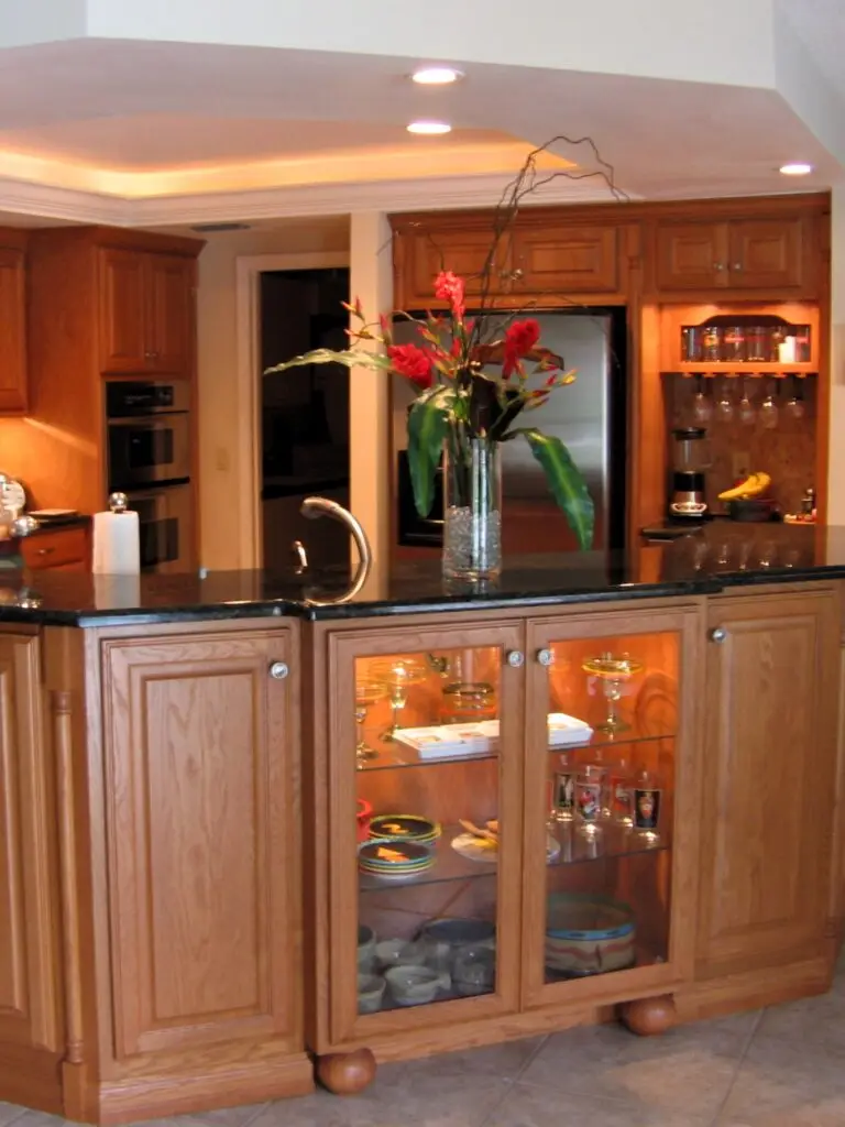 A footed display cabinet serving as a kitchen architectural focal point