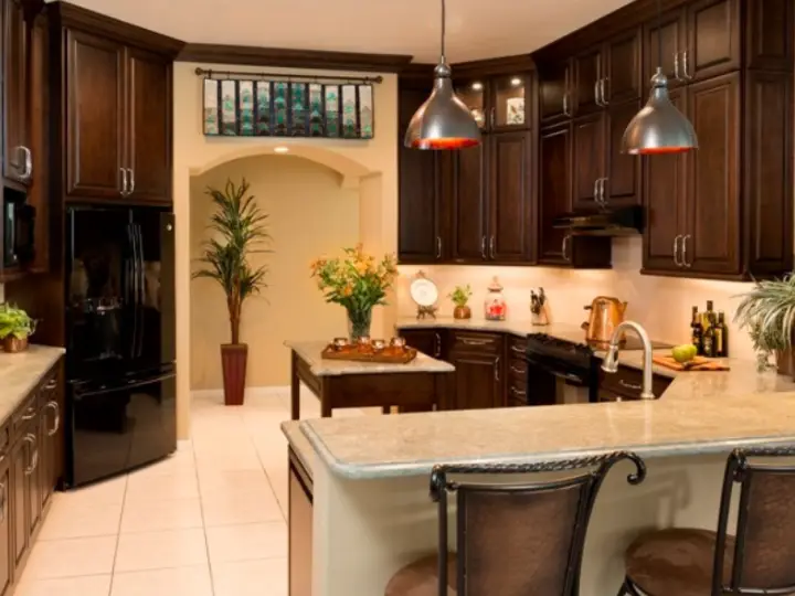 A high-ceiling kitchen with an arched doorway creating negative space