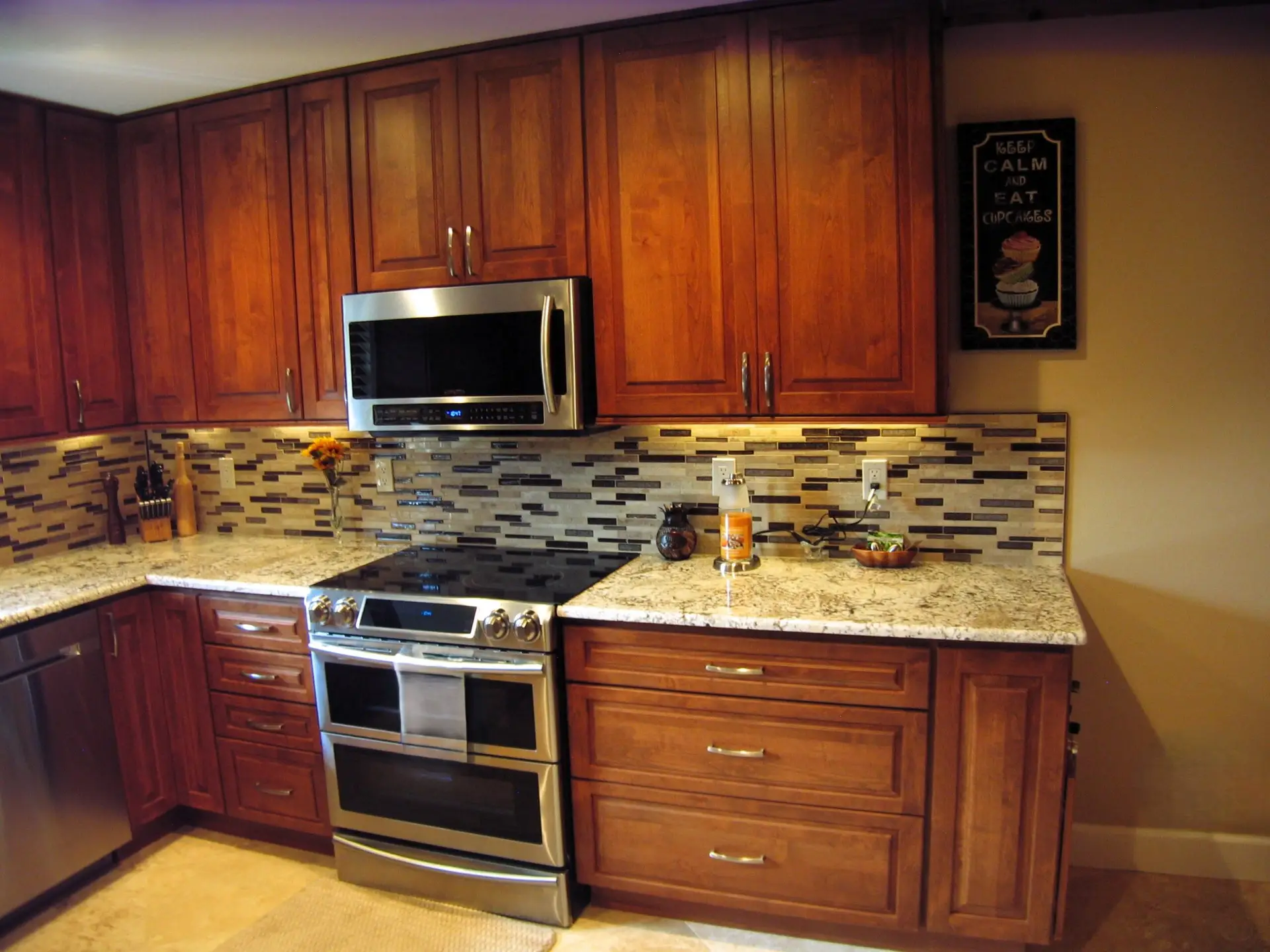 A slide in range highlights the colorful backsplash tile in the Braden Woods kitchen remodel