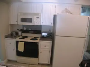Before photo of the dated and mismatched appliances