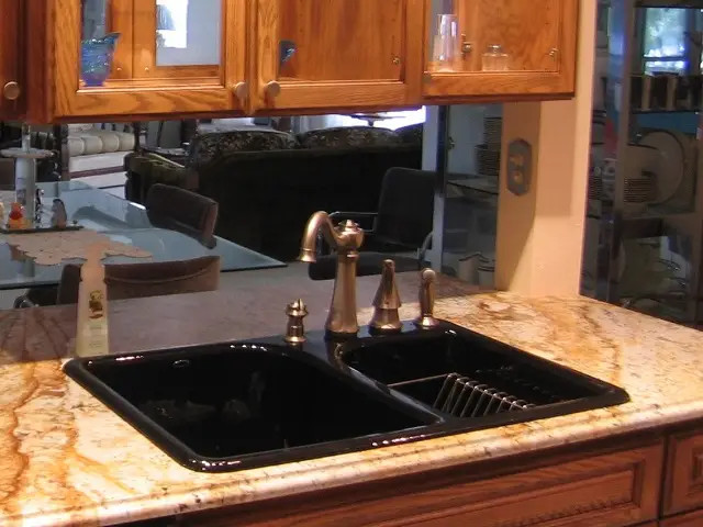 A glossy black drop in procelain sink with an 80 20 bowl spilt