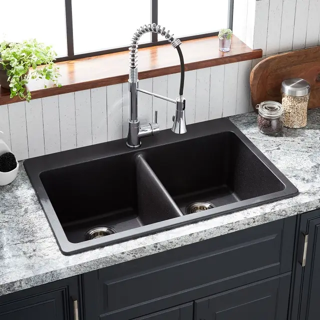 Black contemporary composite granite kitchen sink with a drop in style and a split double bowl
