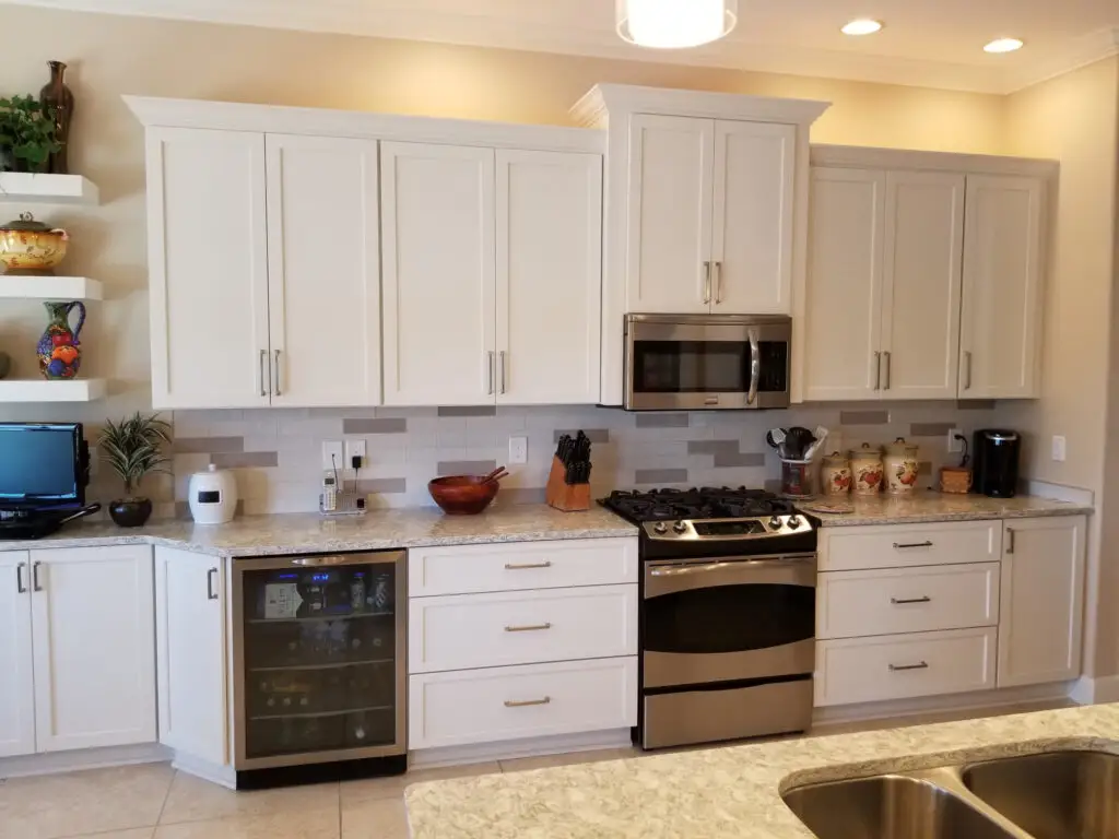 StarMark Maple Roseville cabinetry with Marshmallow Cream finish in a contemporary kitchen, highlighting storage and a built-in wine fridge