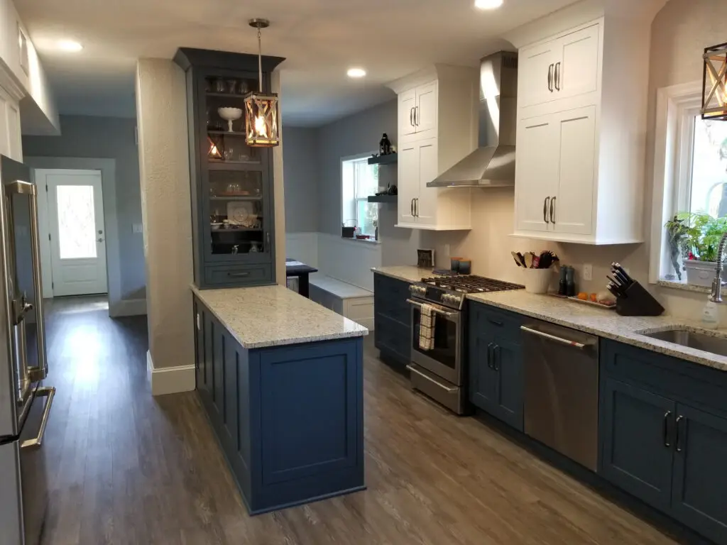 1920s estate kitchen renovation with white and blue cabinets or Classic kitchen revival featuring StarMark Cabinetry