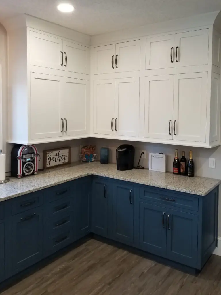 White and Capri blue stacked inset maple kitchen cabinets with White Ornamental granite countertops