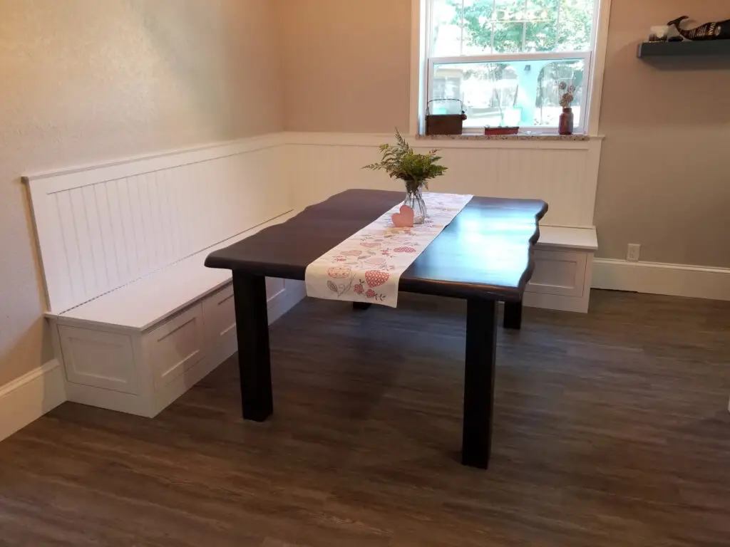 Cozy kitchen banquette with built-in seating in a renovated 1920s estate