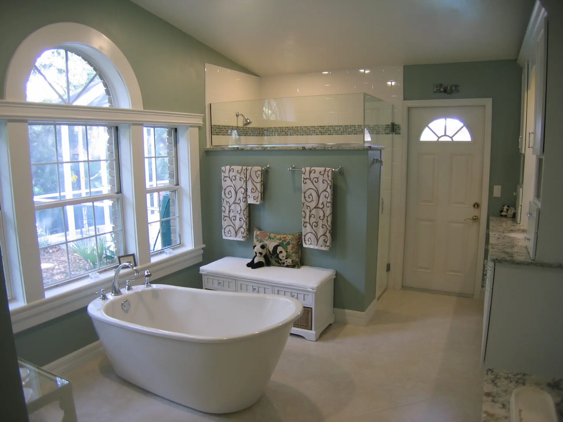 master bath design and remodel by Duncan's Creative Kitchens featuring a soaking tub under a picture window