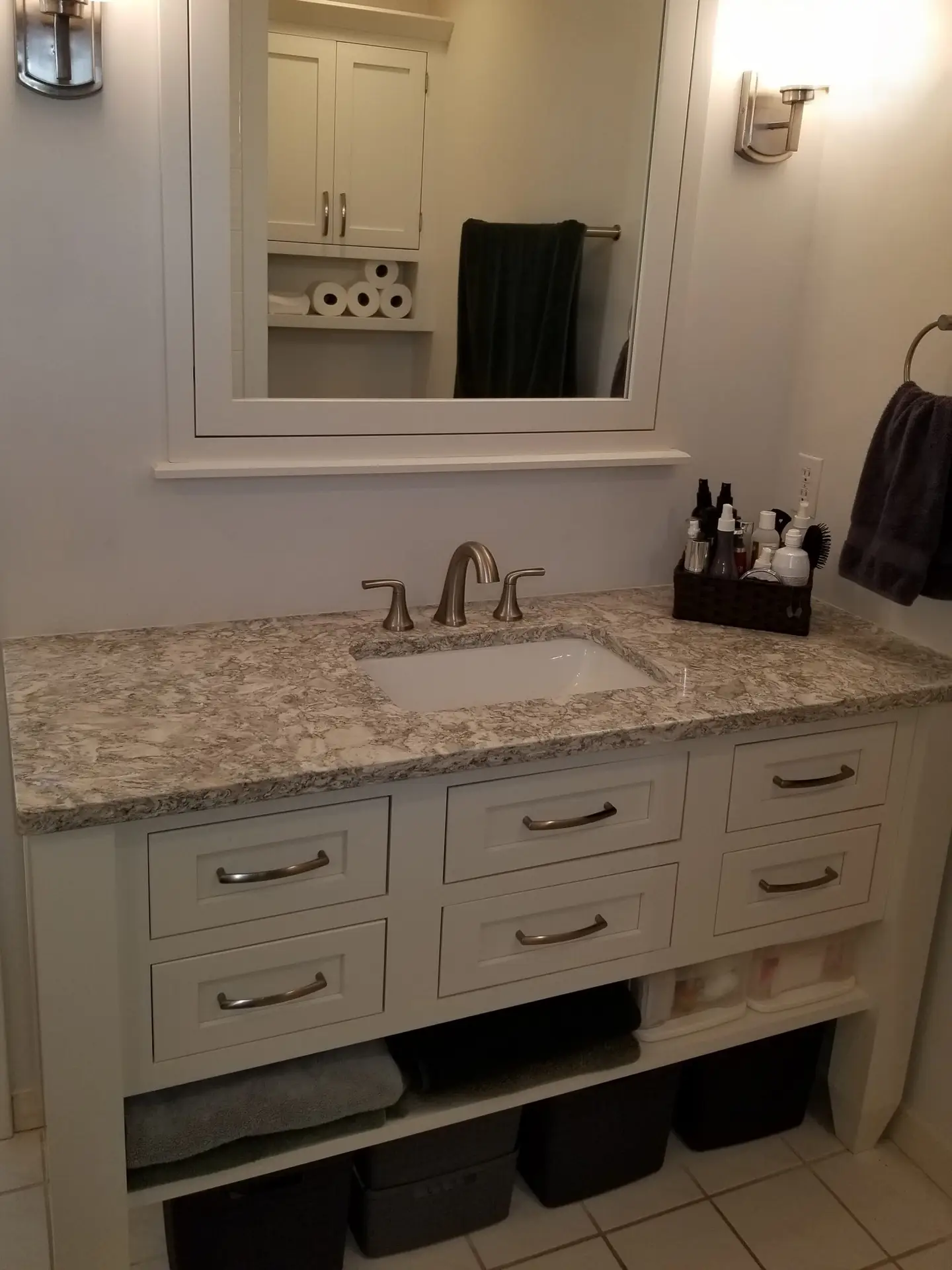 furniture style bathroom vanity cabinet with legs, open shelf, and matching framed mirror