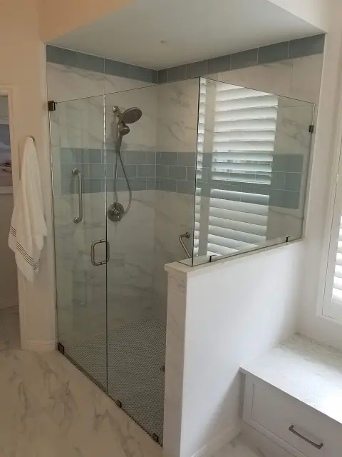 Luxurious custom walk-in shower with natural stone tile in a renovated bathroom in Manatee County