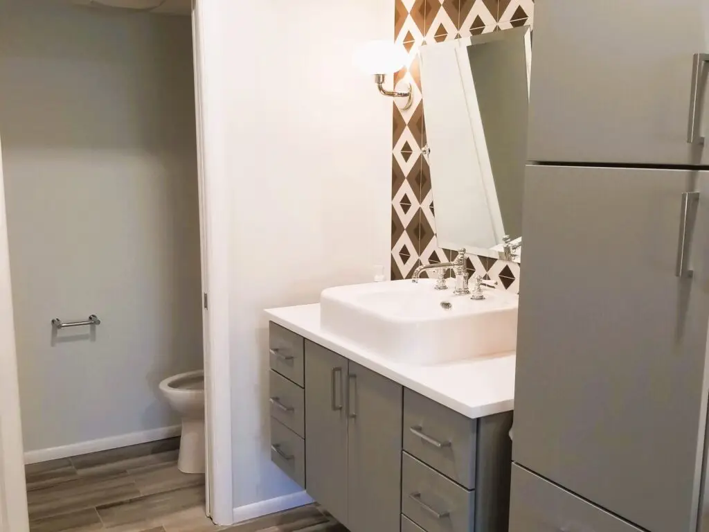 A close-up of a modern bathroom vanity featuring a high-contrast countertop, lever-style faucets, and a sleek design that is both stylish and accessible