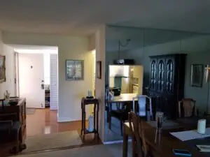 A mirrored partition wall creates a separate and small condo in this Before photo