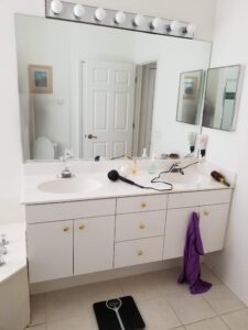 Before photo of a cramped vanity built for two with no counter space