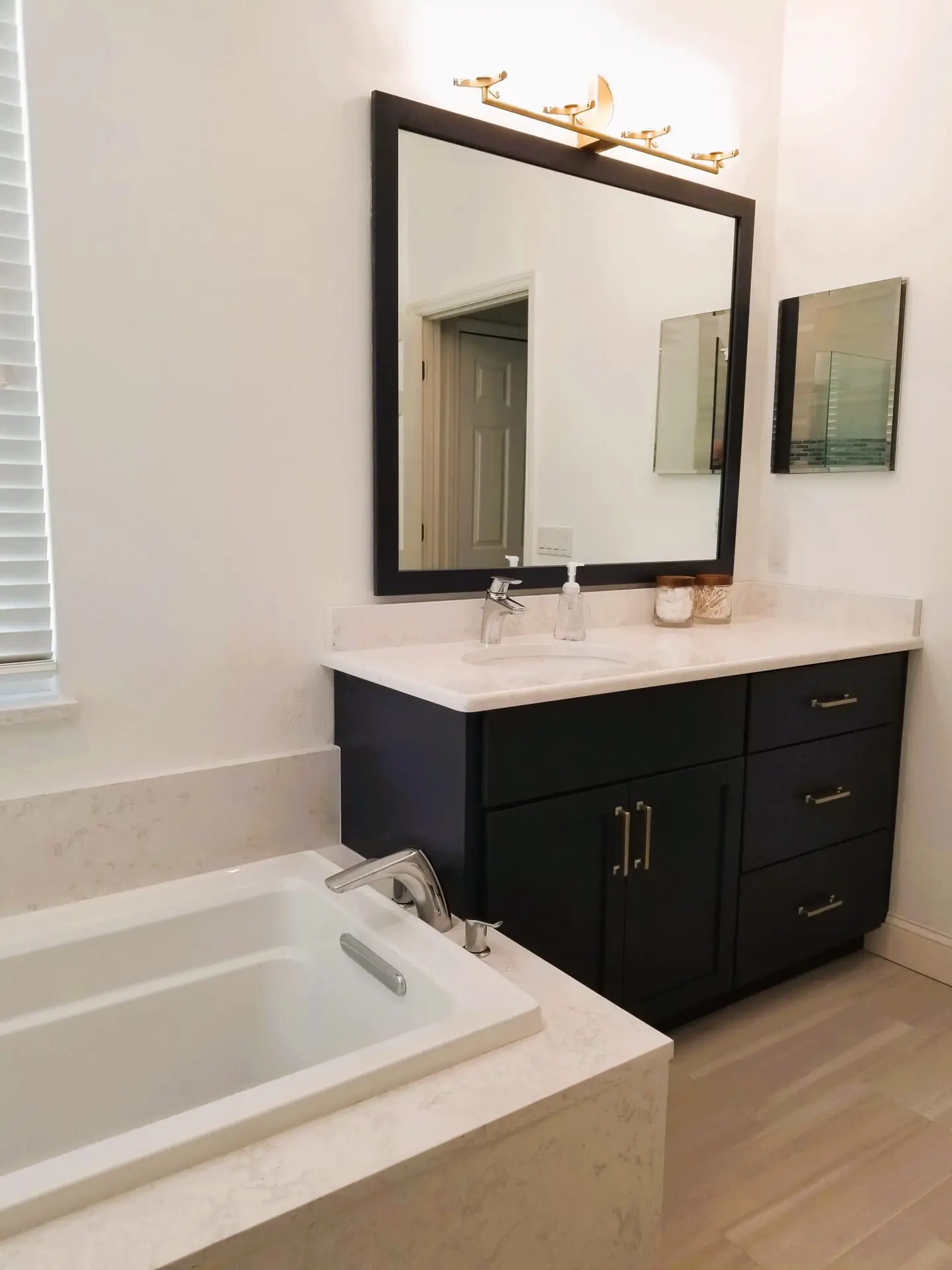 StarMark Cabinetry vanity and Kohler soaking tub with Cambria Torquay counters