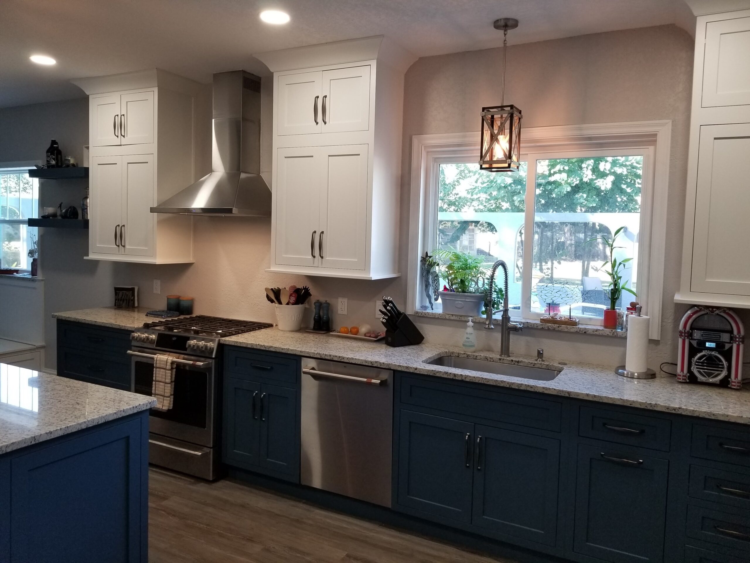 A stunning, modern kitchen remodel with blue and white cabinets