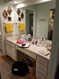 Before photo of the master dressing area showing the asymmetrical vanity and lack of privacy