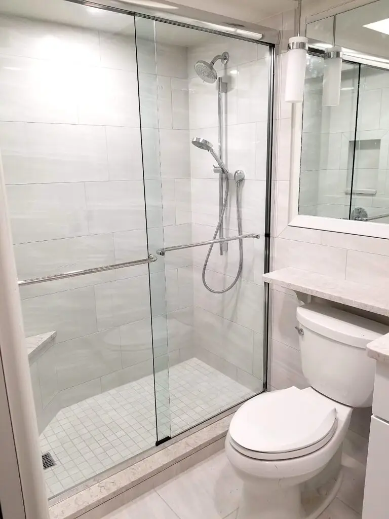 Modern shower with clear glass and corner seat in master bathroom