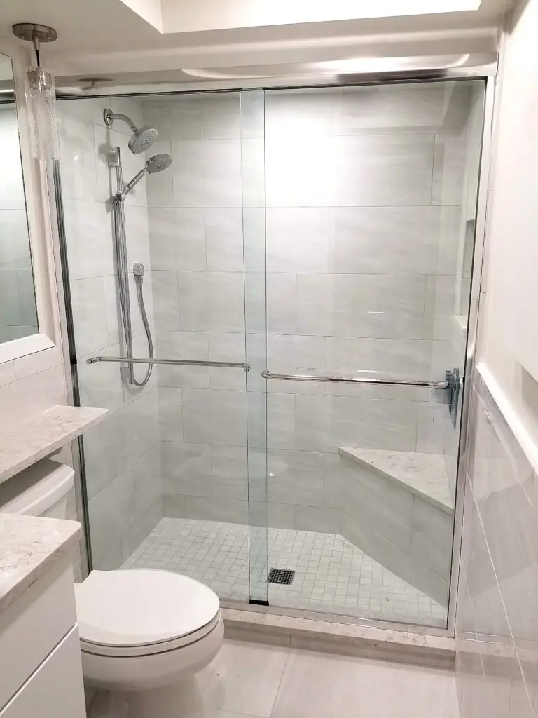 Renovated hall bathroom shower with niche and handheld showerhead